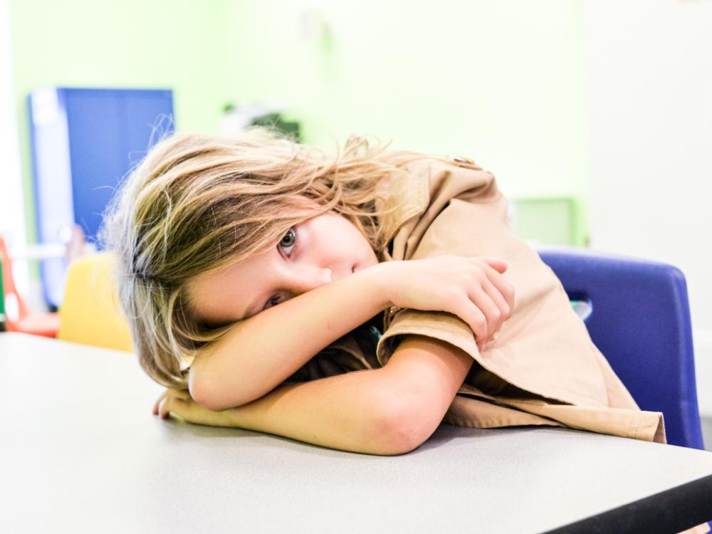 sad child at desk