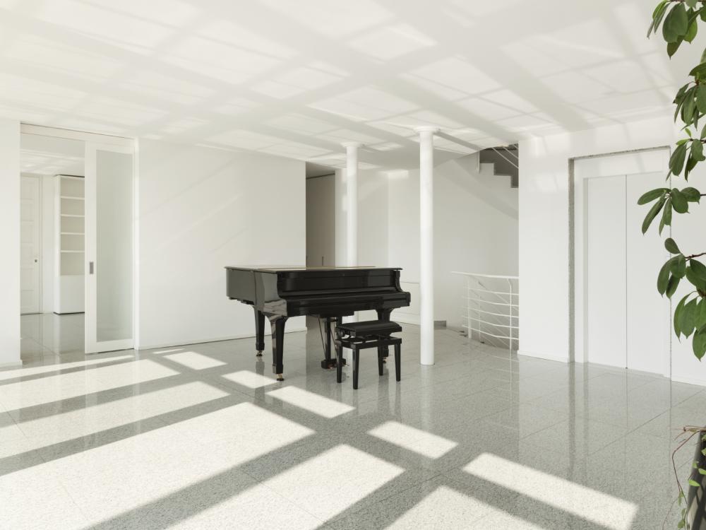 black baby grand in white room