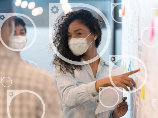 Circle icons overlay a photo of a person wearing a mask pointing at a board