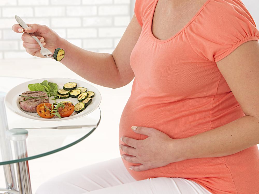 Pregnant woman eating healthy food