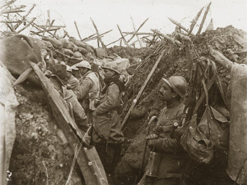 World War I soldiers standing in battlefield trenches 