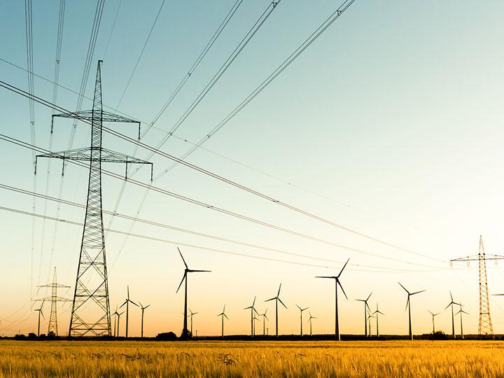 wind turbines and power lines over a field