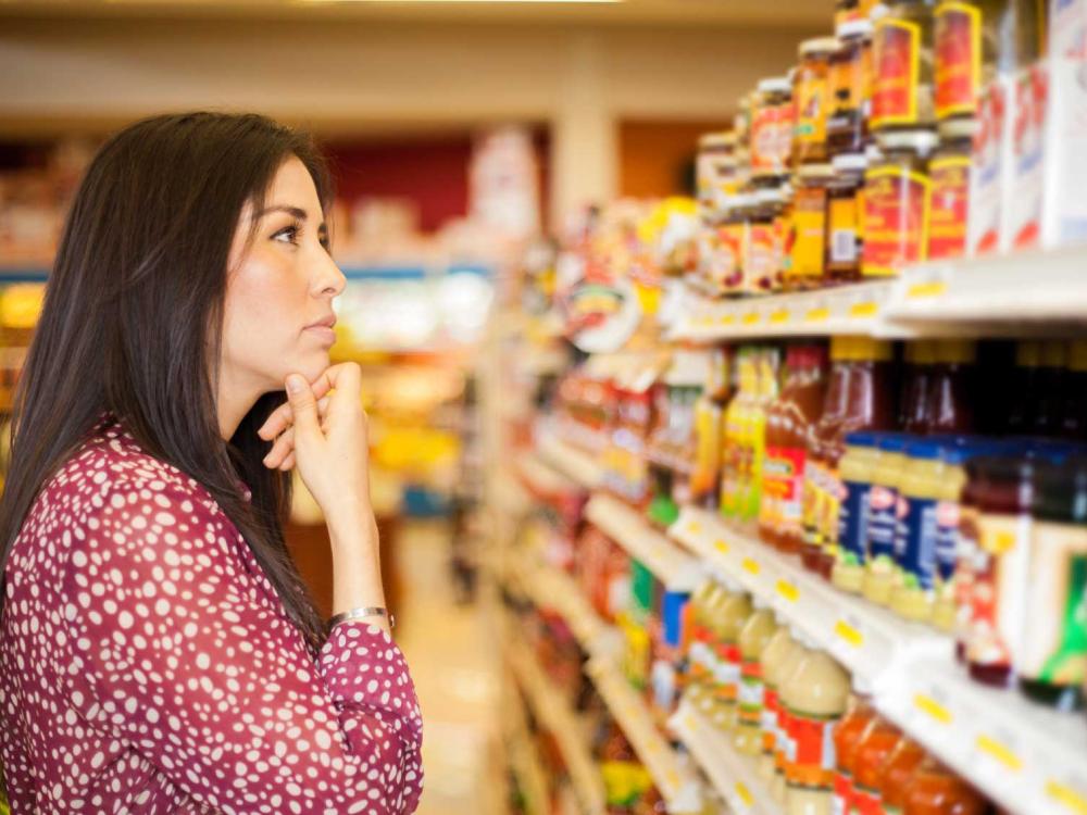 woman looking at grocery store shelf