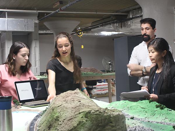 Magdalia Campobasso and Olivia Palmieri show their work to the judge’s panel during the final round of the WE Design Competition.