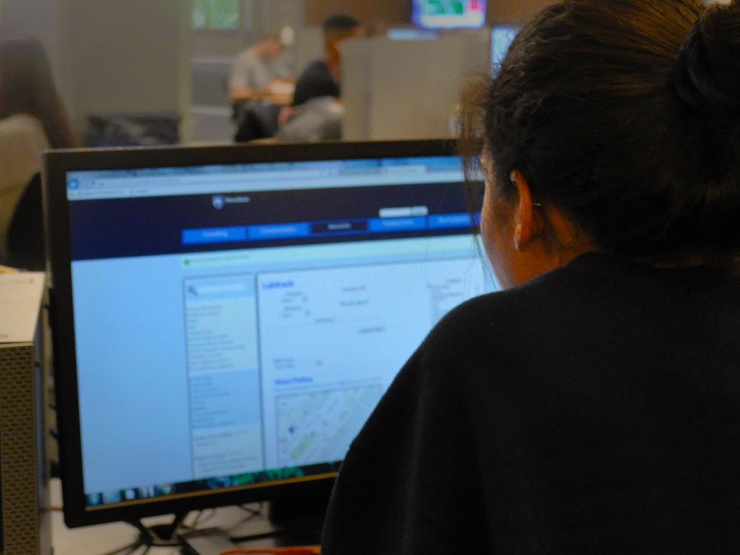 Student works at a computer in campus computer lab