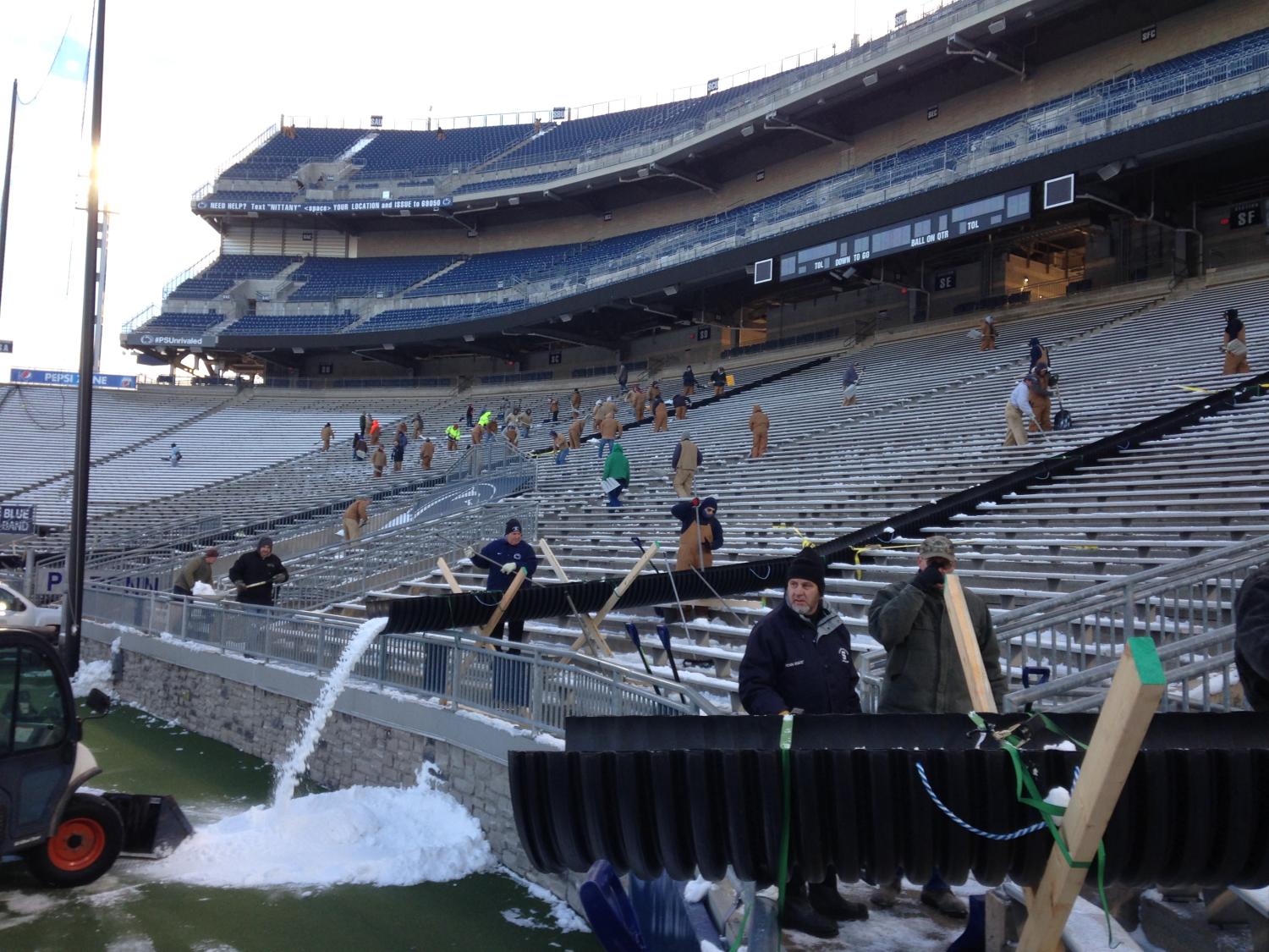 OPP clears snow from student section in Beaver Stadium.