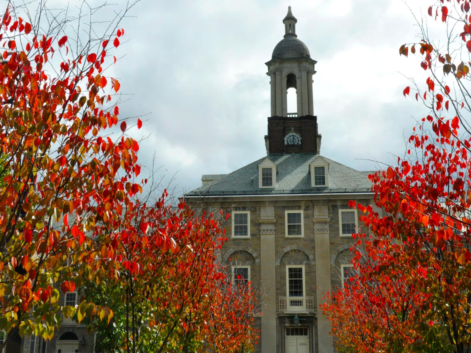 View of Old Main surrounded by red fall leaves