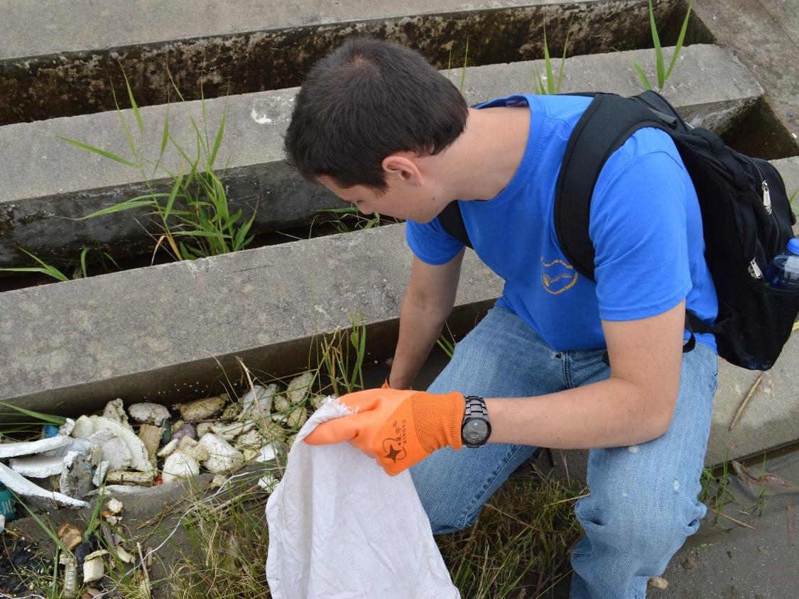 A man picks up trash