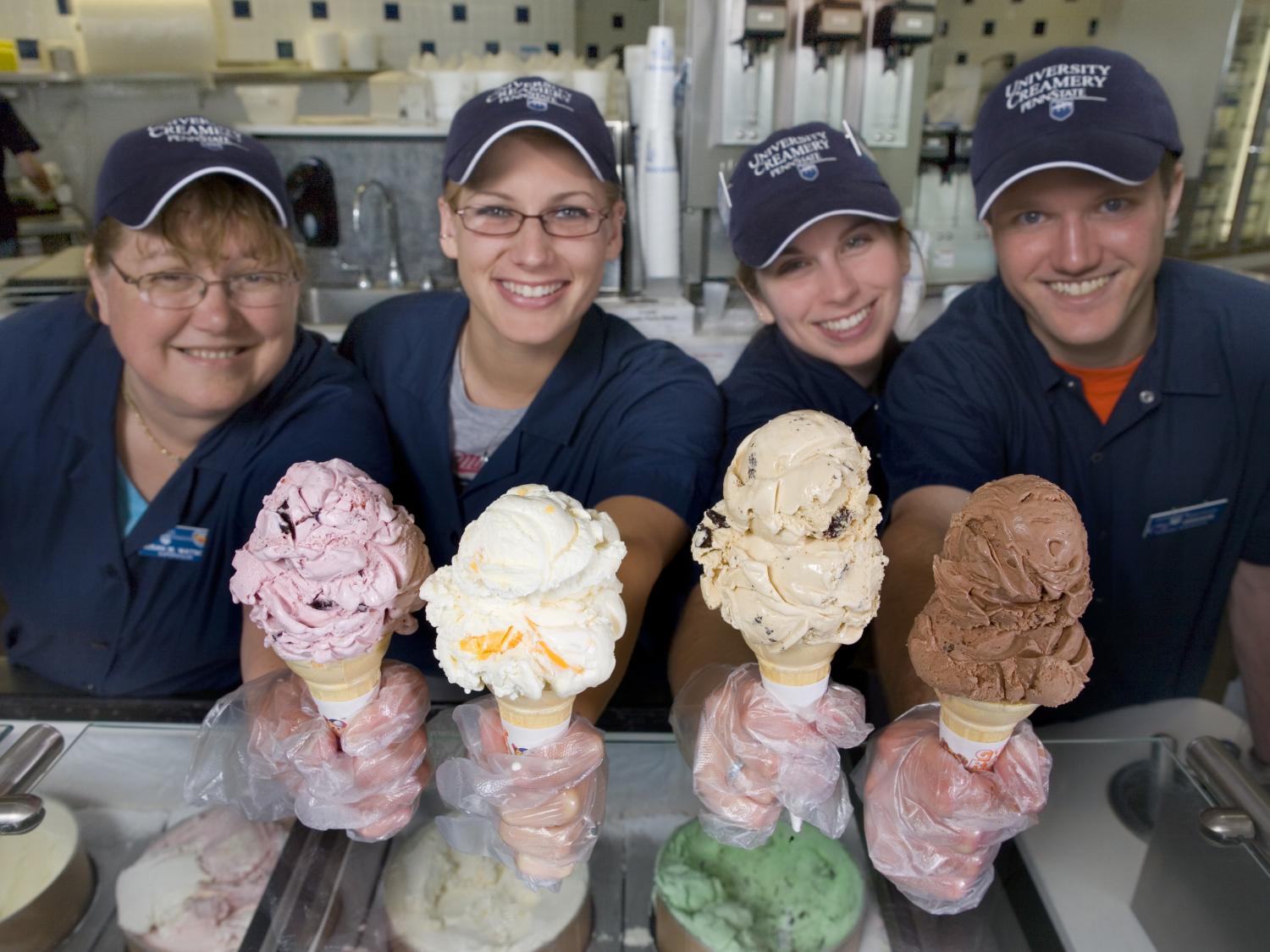 Employees of the Penn State Berkey Creamery show off samples of ice cream.