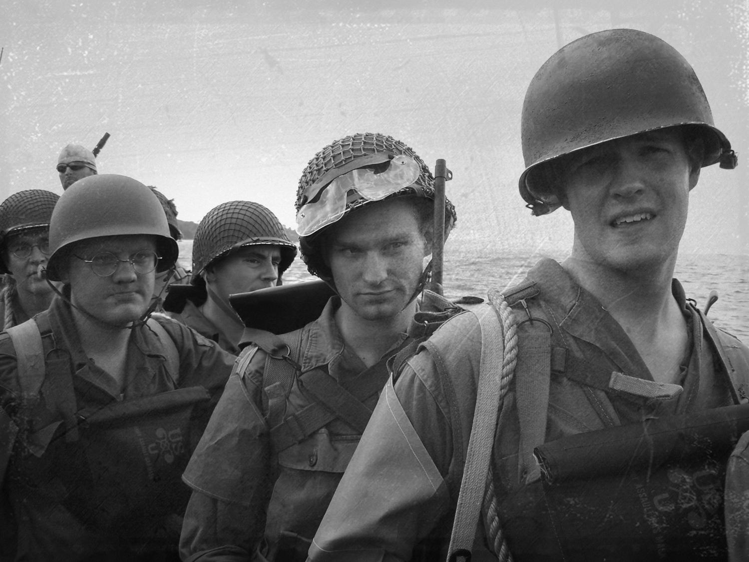 Four men in a WWII reenactment group in soldiers' apparel