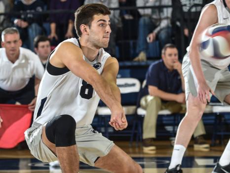 Penn State volleyball hitter Aaron Russell goes low for a dig