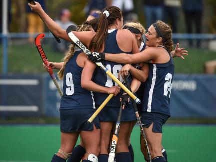 Members of the 2014 Penn State field hockey team crowd together in celebration following a score