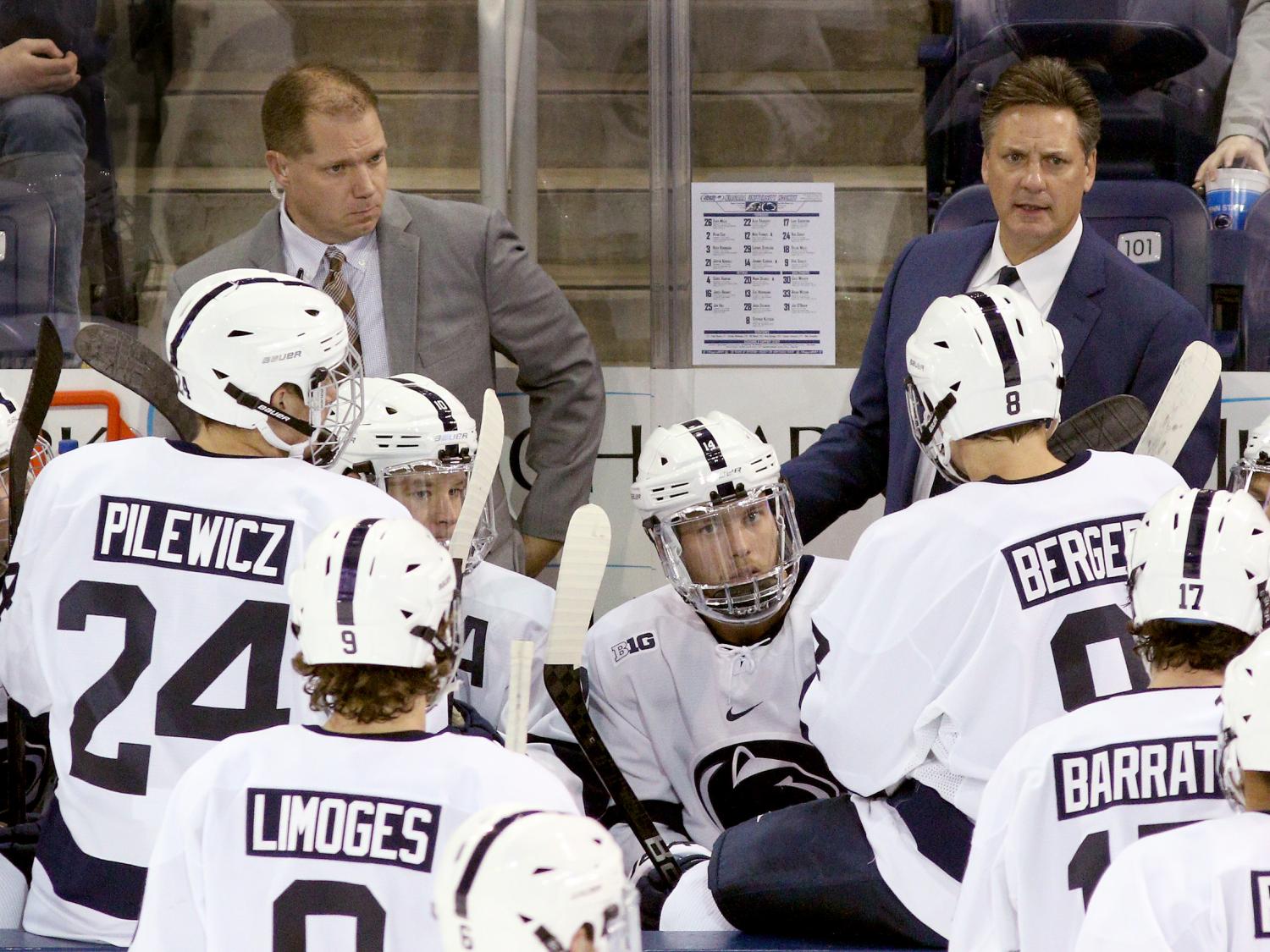 man coaching ice hockey team in competition