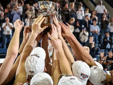 Penn State men's volleyball team members hold up the 2015 EIVA Championship trophy