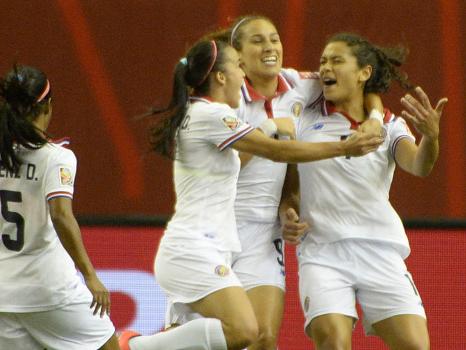 Members of the Costa Rica national team celebrate Raquel Rodriguez's goal