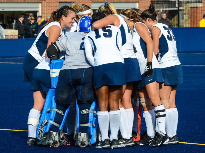 Field hockey team in huddle