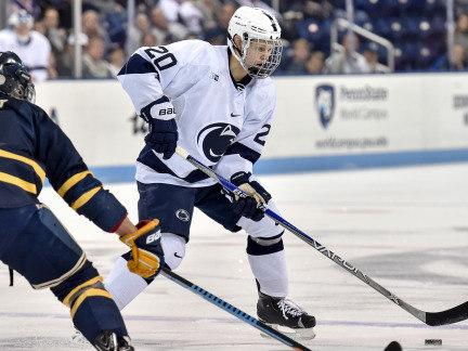 Men's hockey player with puck