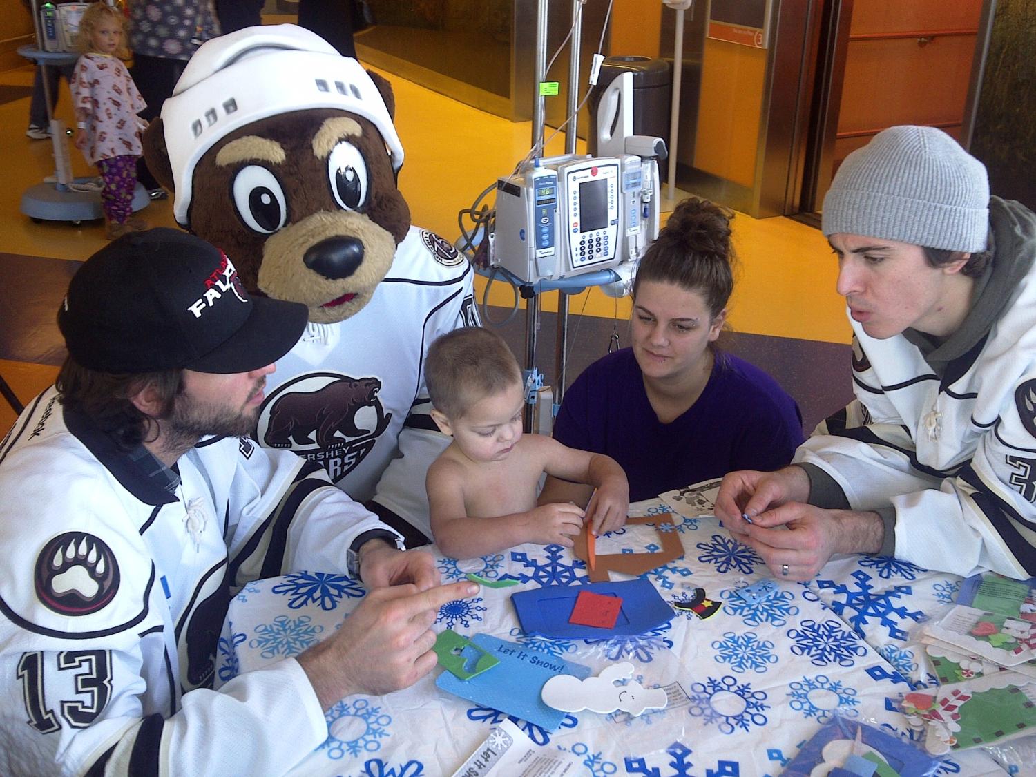 Players visit with children