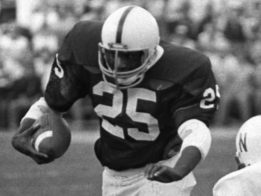 Curt Warner running football in archive photo