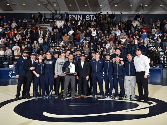 Wrestlers pose with Big Ten trophy