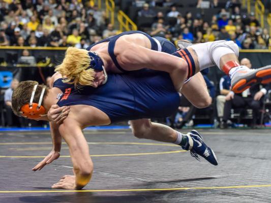 Wrestler takes down opponent