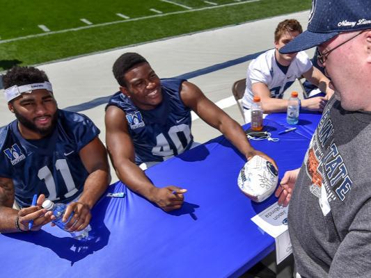 Players sign autographs for fans