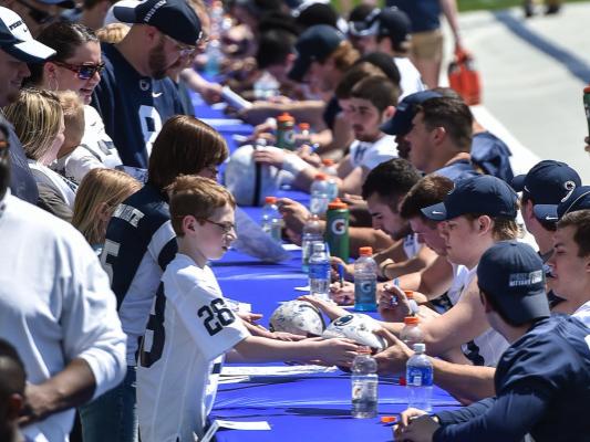 Players sign autographs for fans