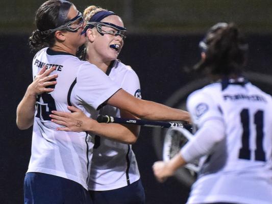 Women lacrosse players celebrate