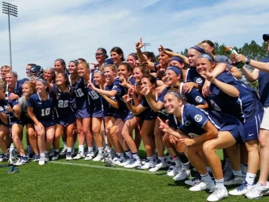 Women's lacrosse team celebrates victory, poses for team photo