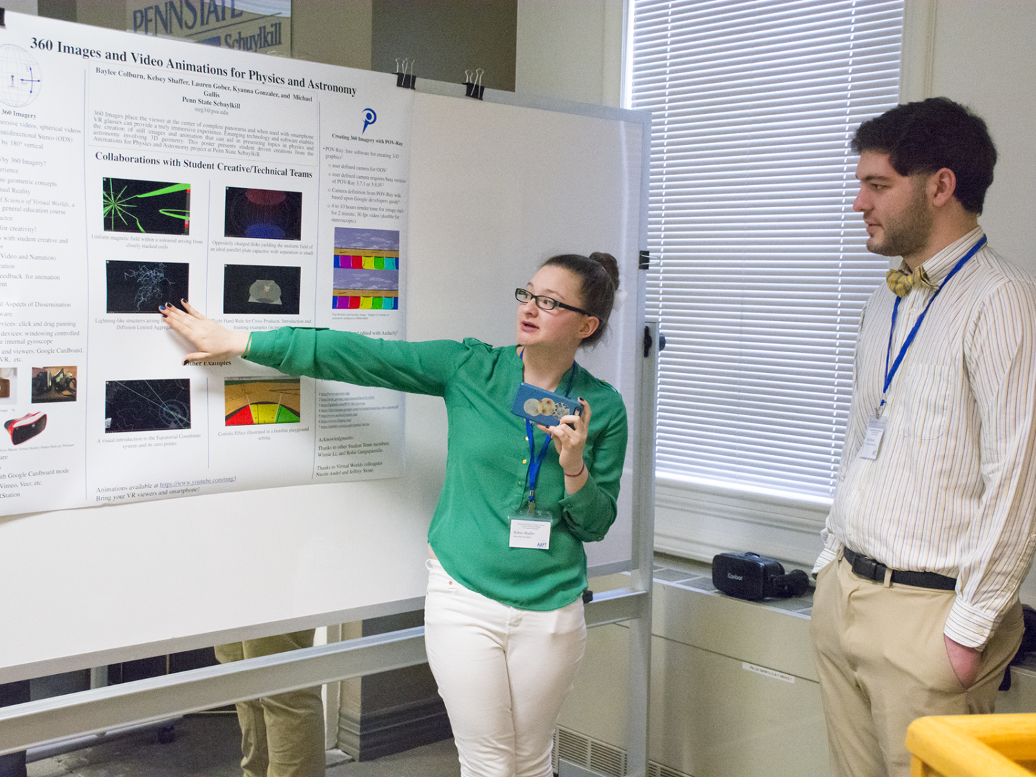 During a research poster session at a Physics Conference, Kelsey Shaffer demonstrates a lightning fractal effect in 3D by using a smartphone. 