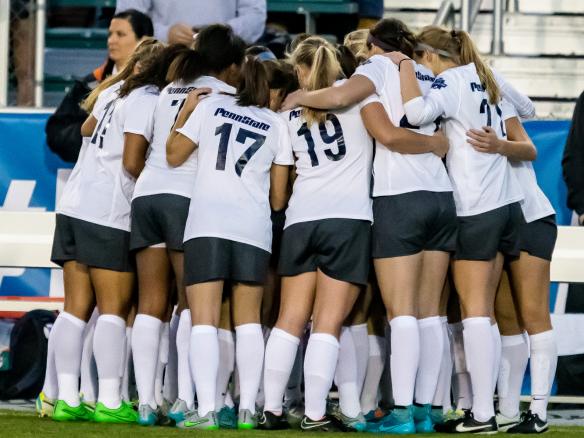 Soccer team huddles