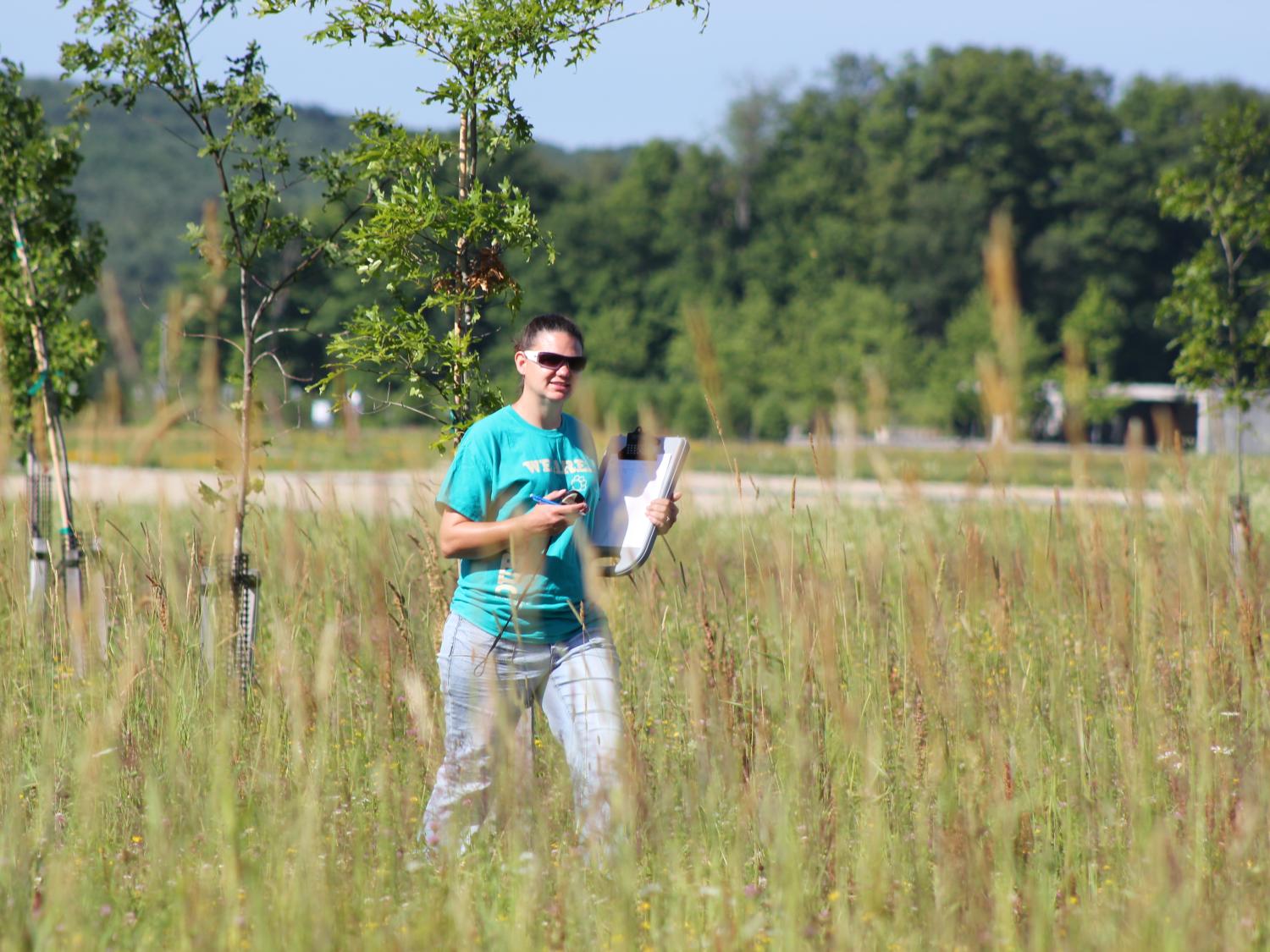 Female student walks in field