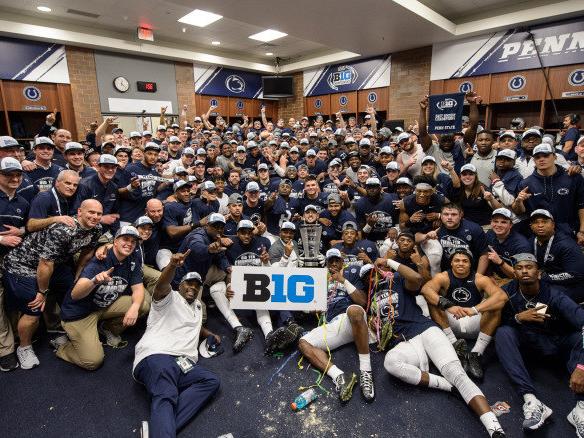 Football team poses in locker room after 2016 Big Ten title game