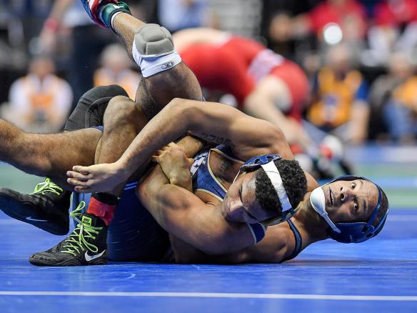 Wrestler takes down opponent