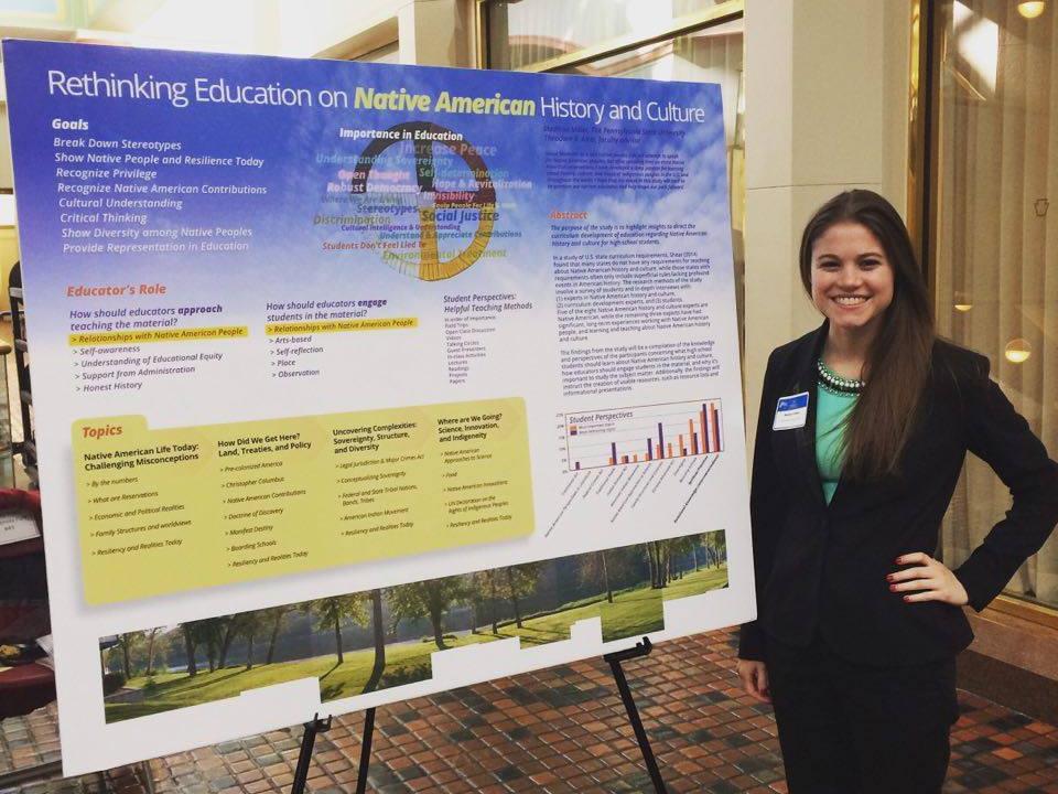 Madison Miller stands besides poster titled "Rethinking Education on Native American History and Culture"