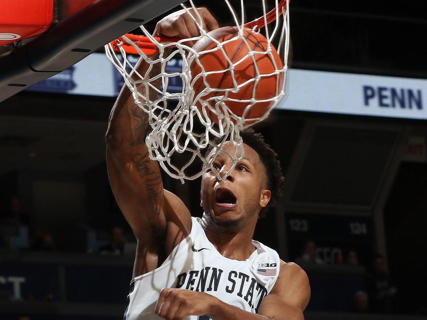 man dunking basketball