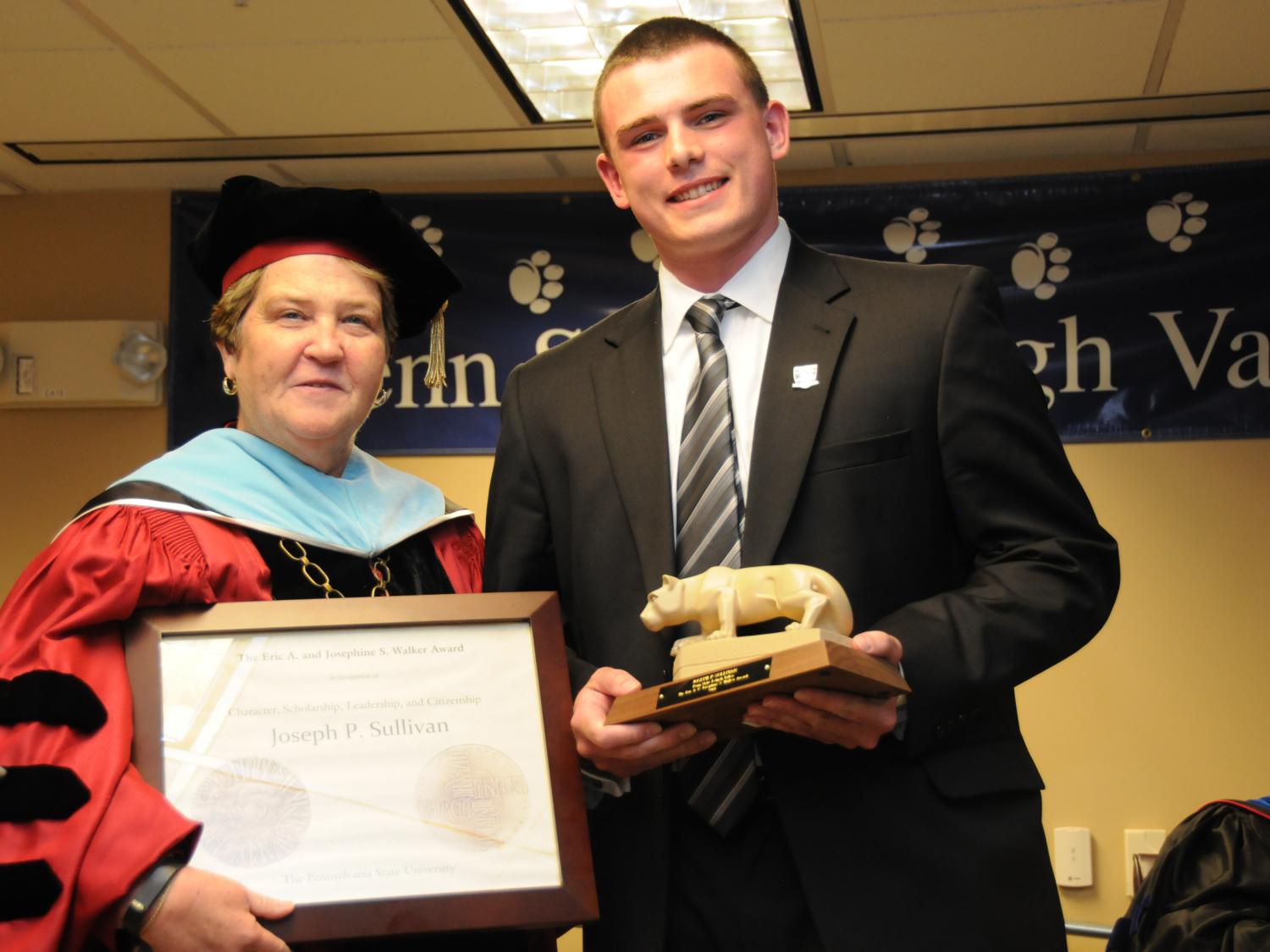 Chancellor Ann Williams presents the 2014 Walker Award to student Joseph Sullivan.
