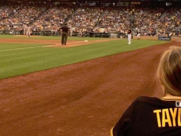 Taylor Myers watches baseball game from field level.