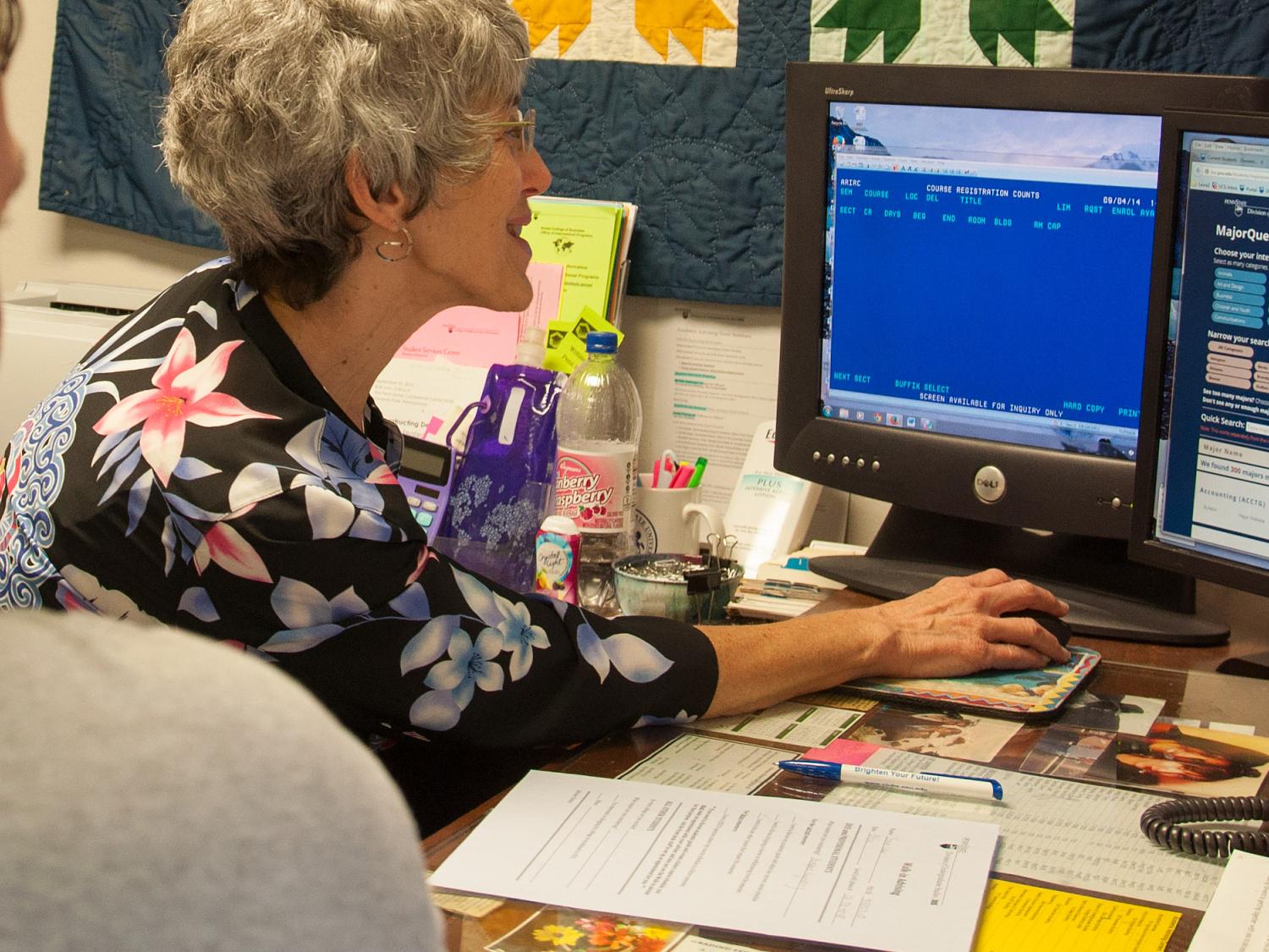 DUS adviser works with student on a computer