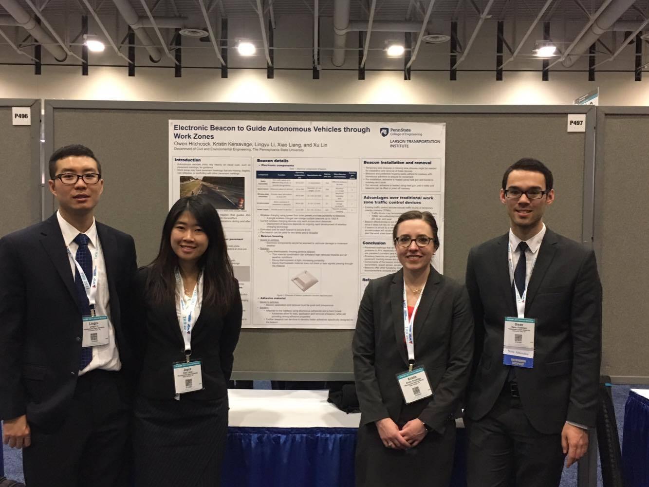 Students standing in front of presentation.