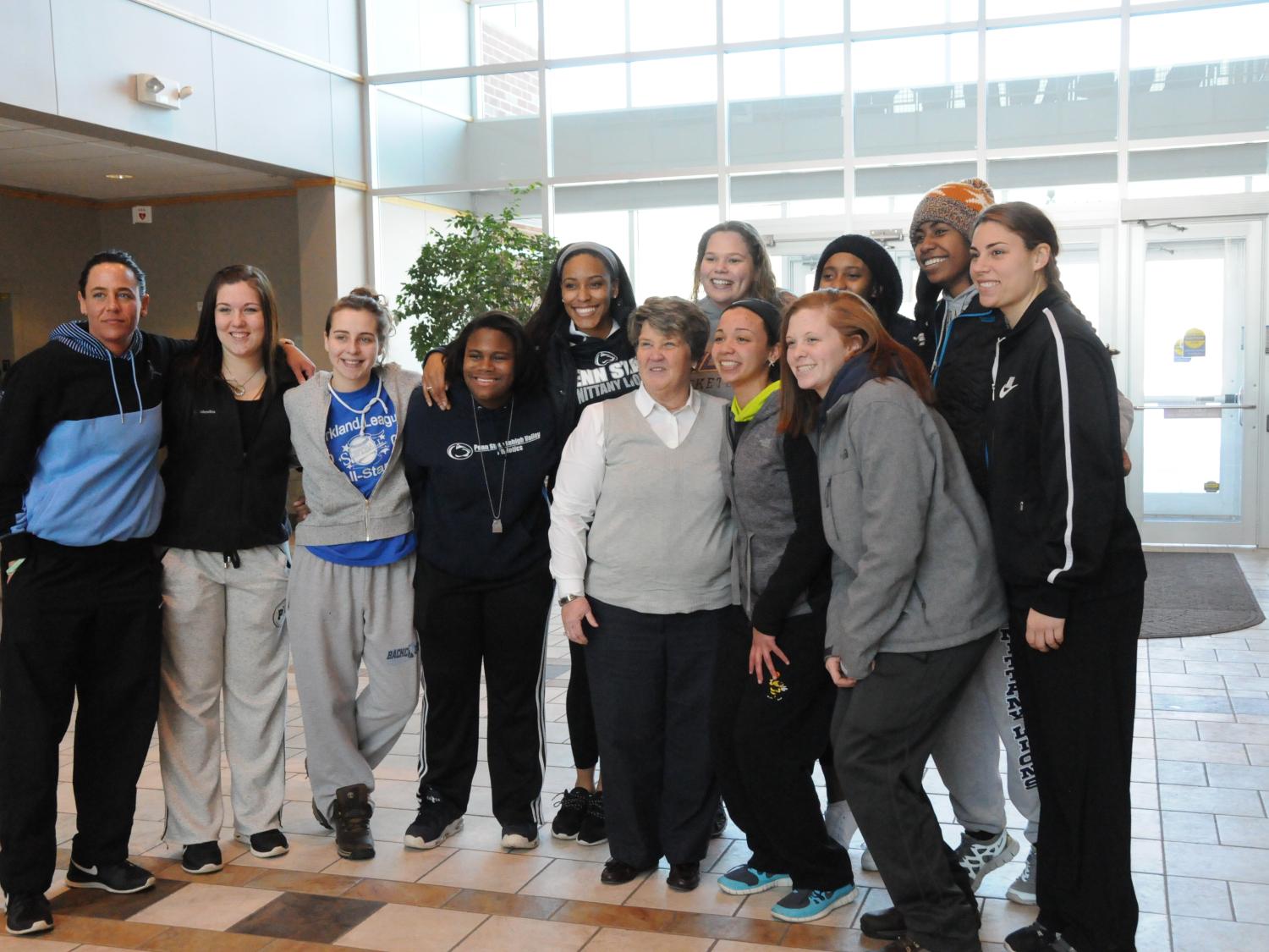 Chancellor and women's basketball team pose for a photo