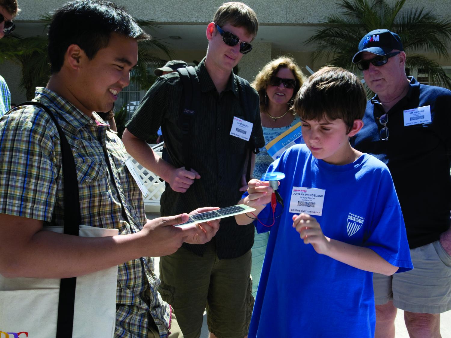 boy looks at solar fan