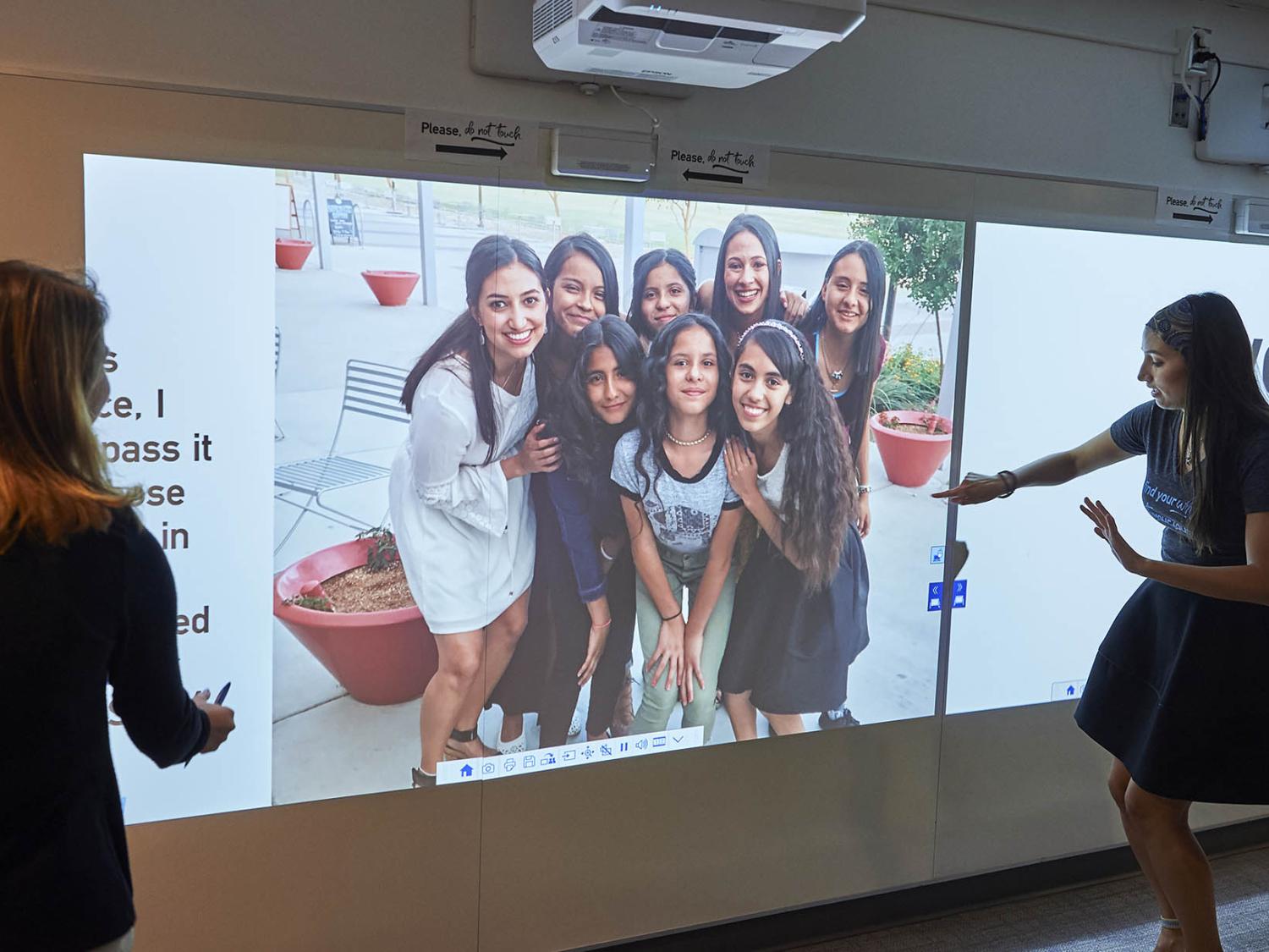 Rhea Sullivan explores the interactive walls in the Engagement Space