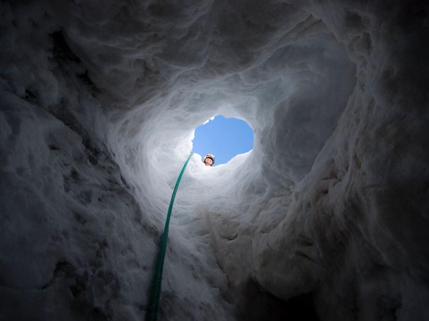 Kiya Riverman looking into a glacial cave