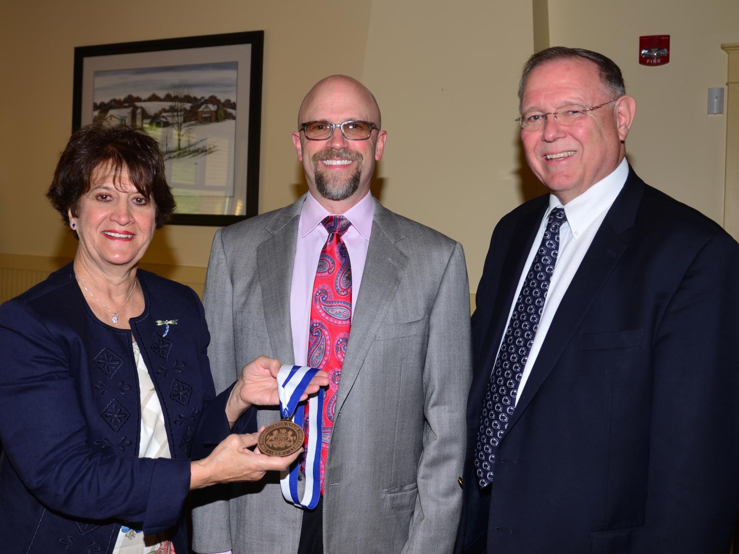 Joshua Swimmer receiving the Outstanding Fellow from Dr. Arlene Hall, Left and William Blaney, right.