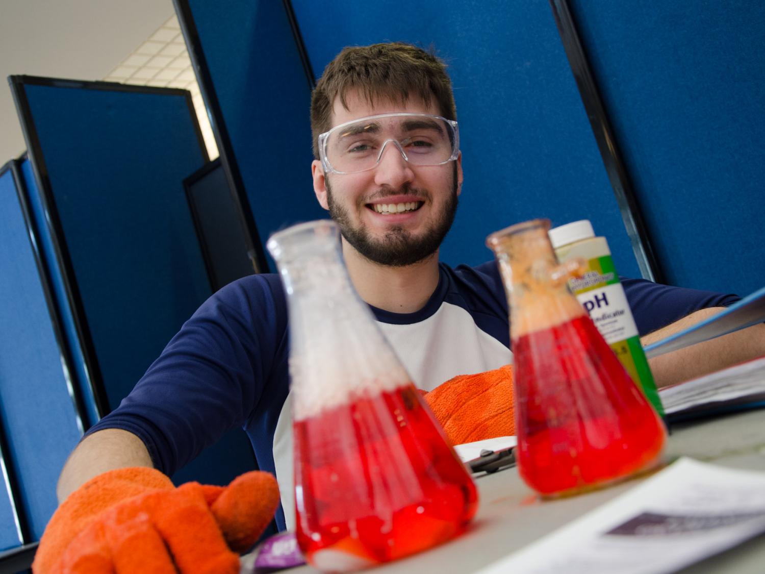 A student behind test tubes