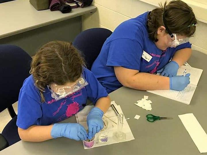 Two young girls working on a project in a Penn State Shenango classroom in 2017.