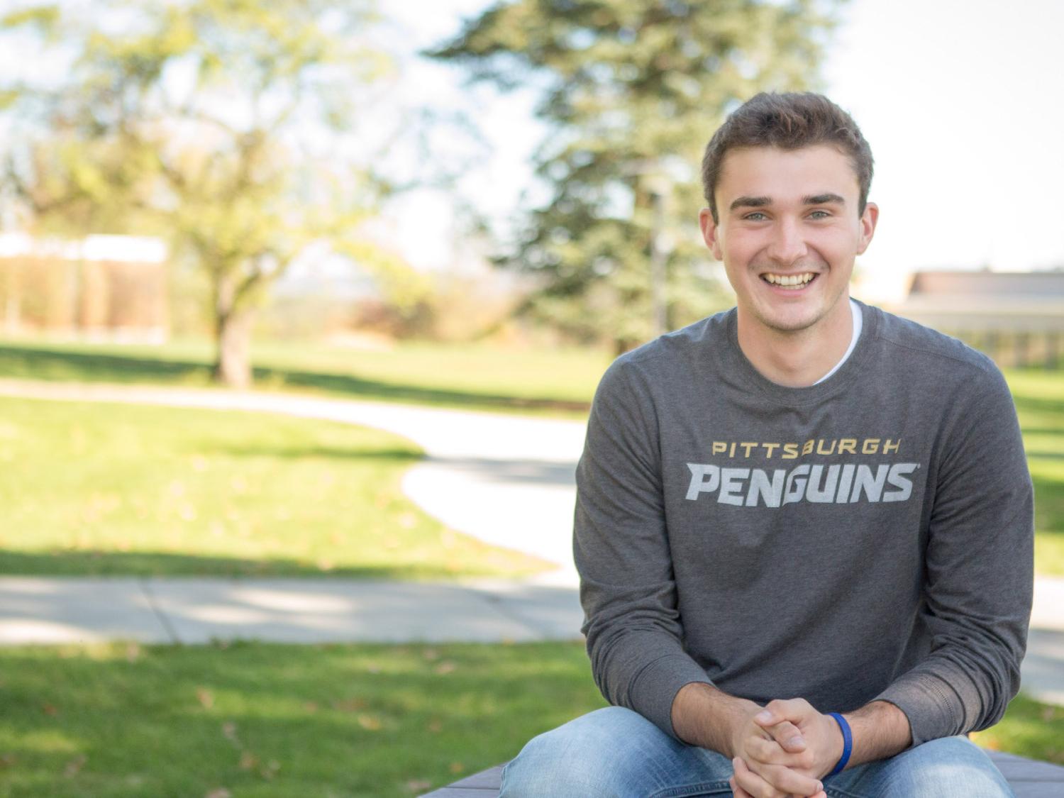 Beaver student Ty Cole sits at picnic table on campus.