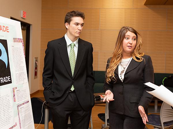 Two students present their project to judges.