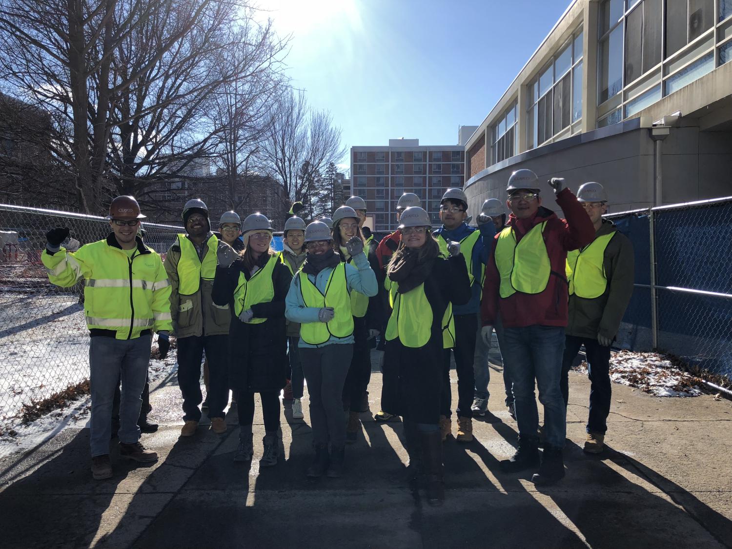 Group photo standing in front of construction project